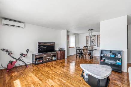 Open living and dining room with hardwood floors in a Howard Beach, Queens NY home — Homes by Agatha