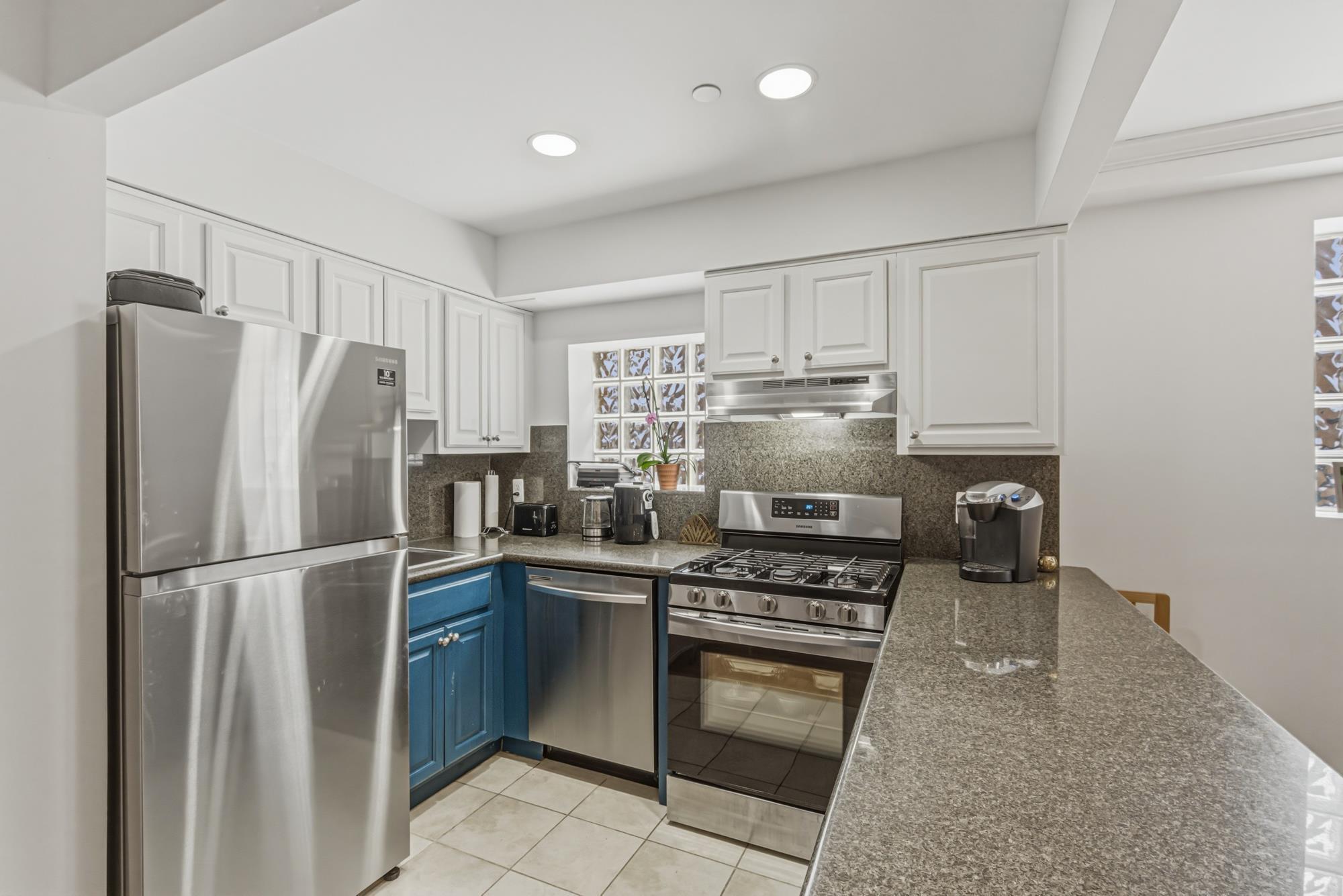 Updated kitchen with stainless steel appliances and granite counters in a Richmond Hill, Queens NY condo — Homes by Agatha