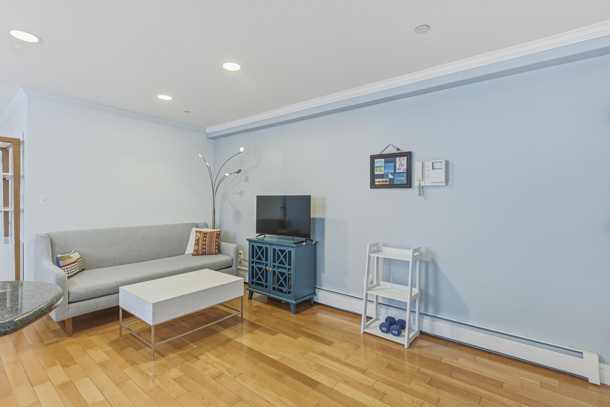 Living room with hardwood floors in a Richmond Hill, Queens NY condo for sale — Homes by Agatha