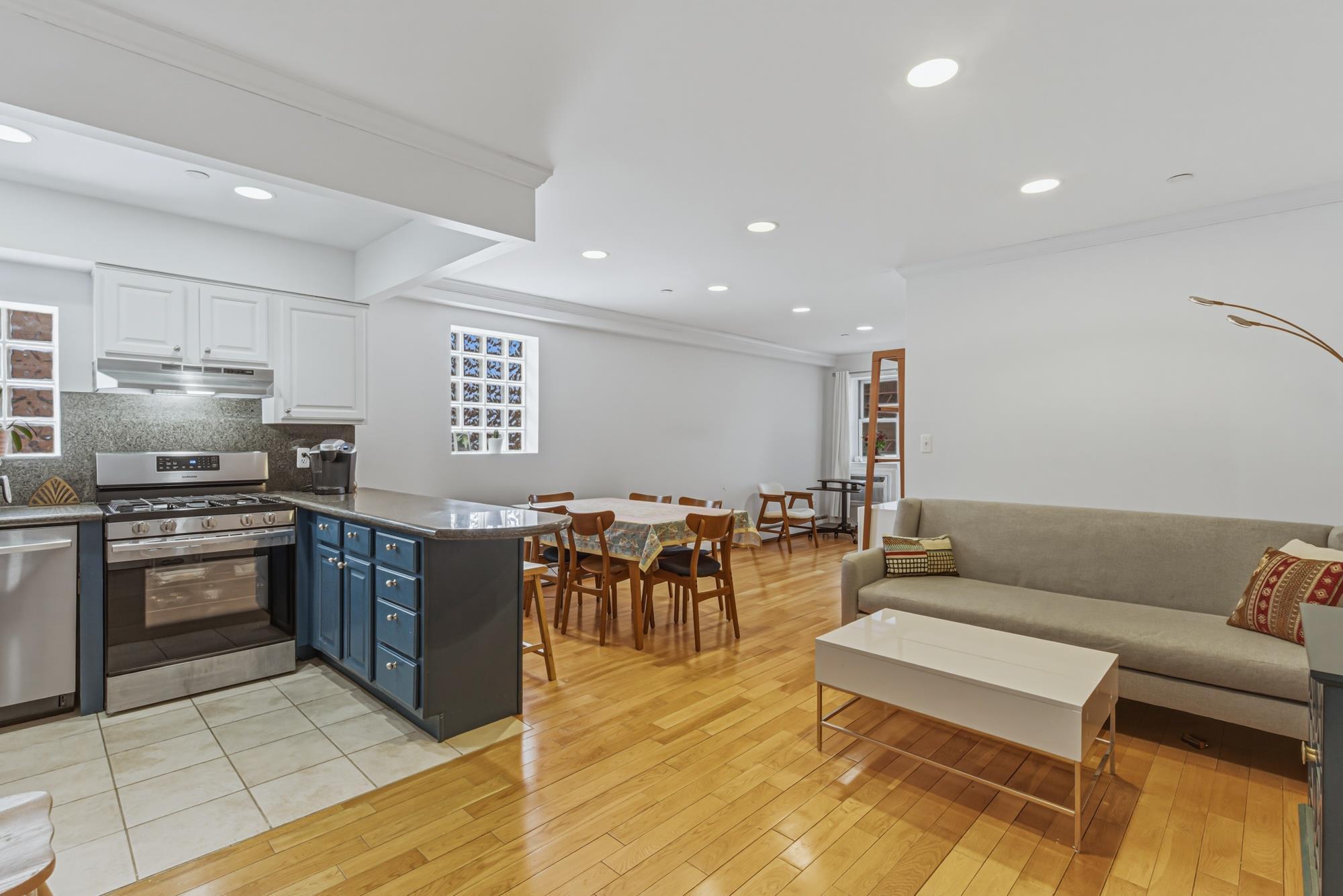 Open-concept living, dining, and kitchen in a Richmond Hill, Queens NY condo for sale — Homes by Agatha
