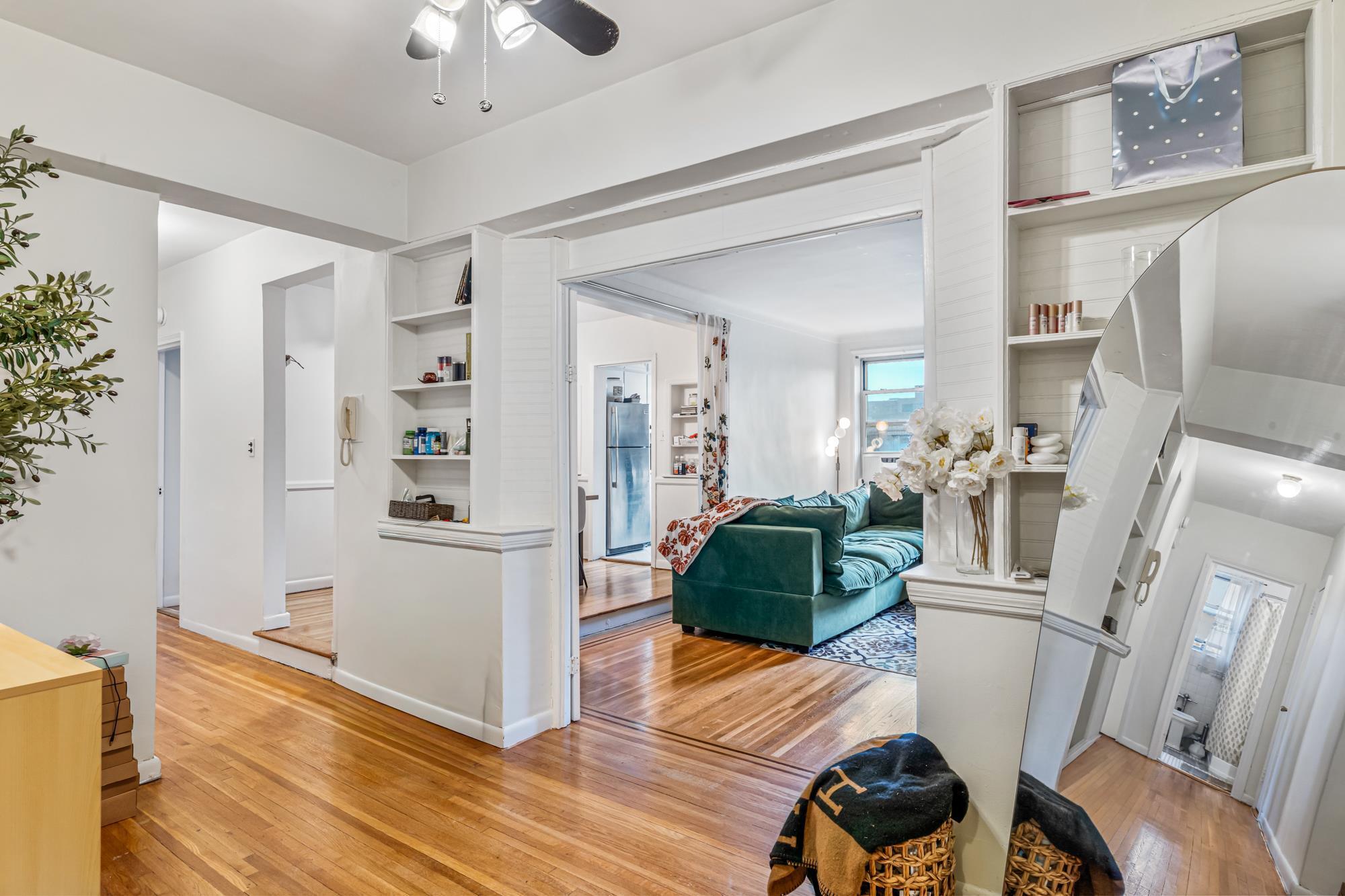 Interior layout showing hallway, living room and bathroom in a Rego Park, Queens NY co-op for sale at 65-74 Saunders Street 6J — Homes by Agatha