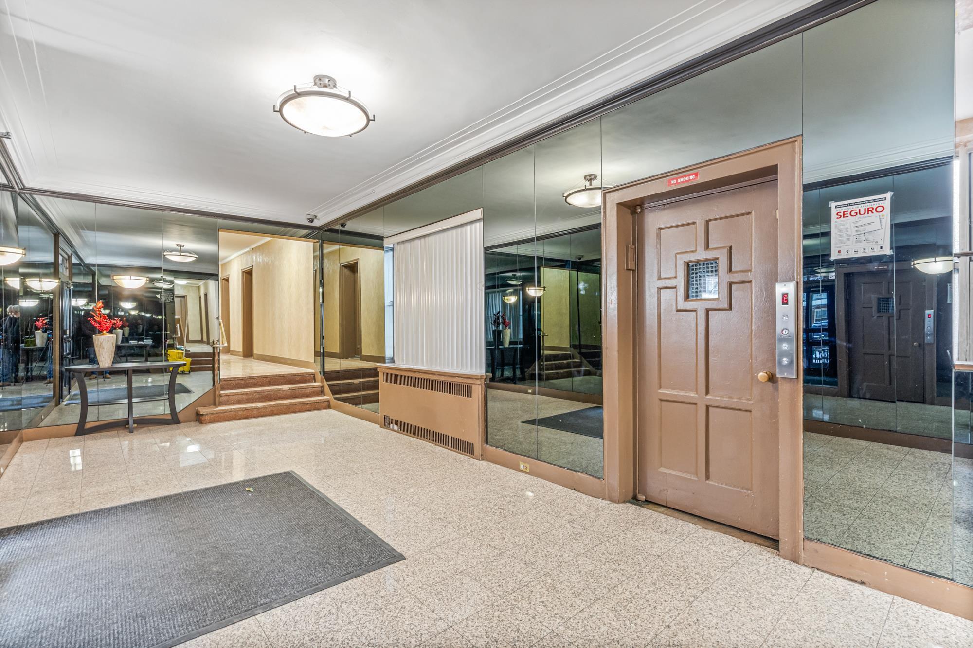 Renovated lobby with elevator in the co-op building at 65-74 Saunders Street, Rego Park, NY — Homes by Agatha