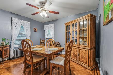 Dining room with hardwood parquet floors in a Queens Village, NY home for sale — Homes by Agatha