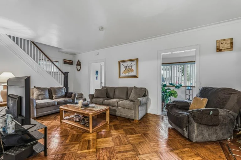 Living room with hardwood parquet floors in a Queens Village, NY home for sale — Homes by Agatha