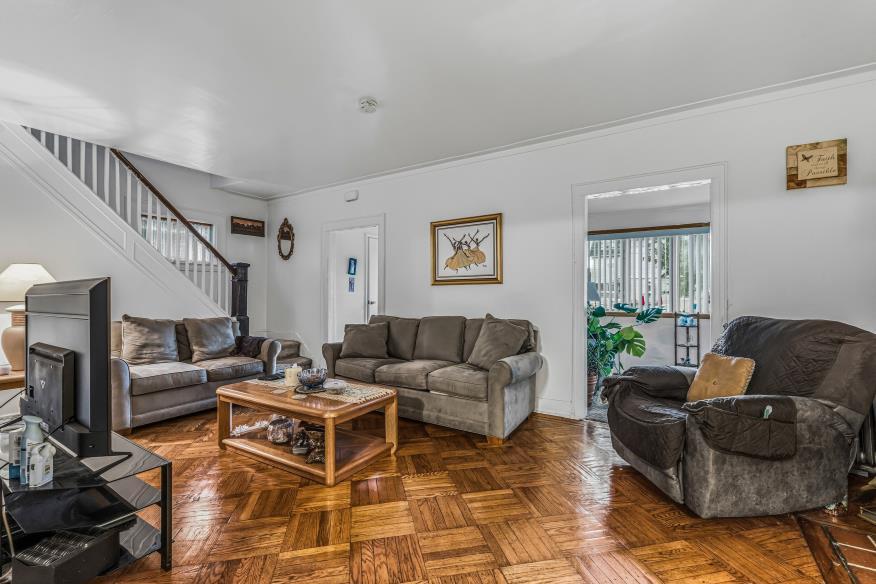 Living room with hardwood parquet floors in a Queens Village, NY home for sale — Homes by Agatha